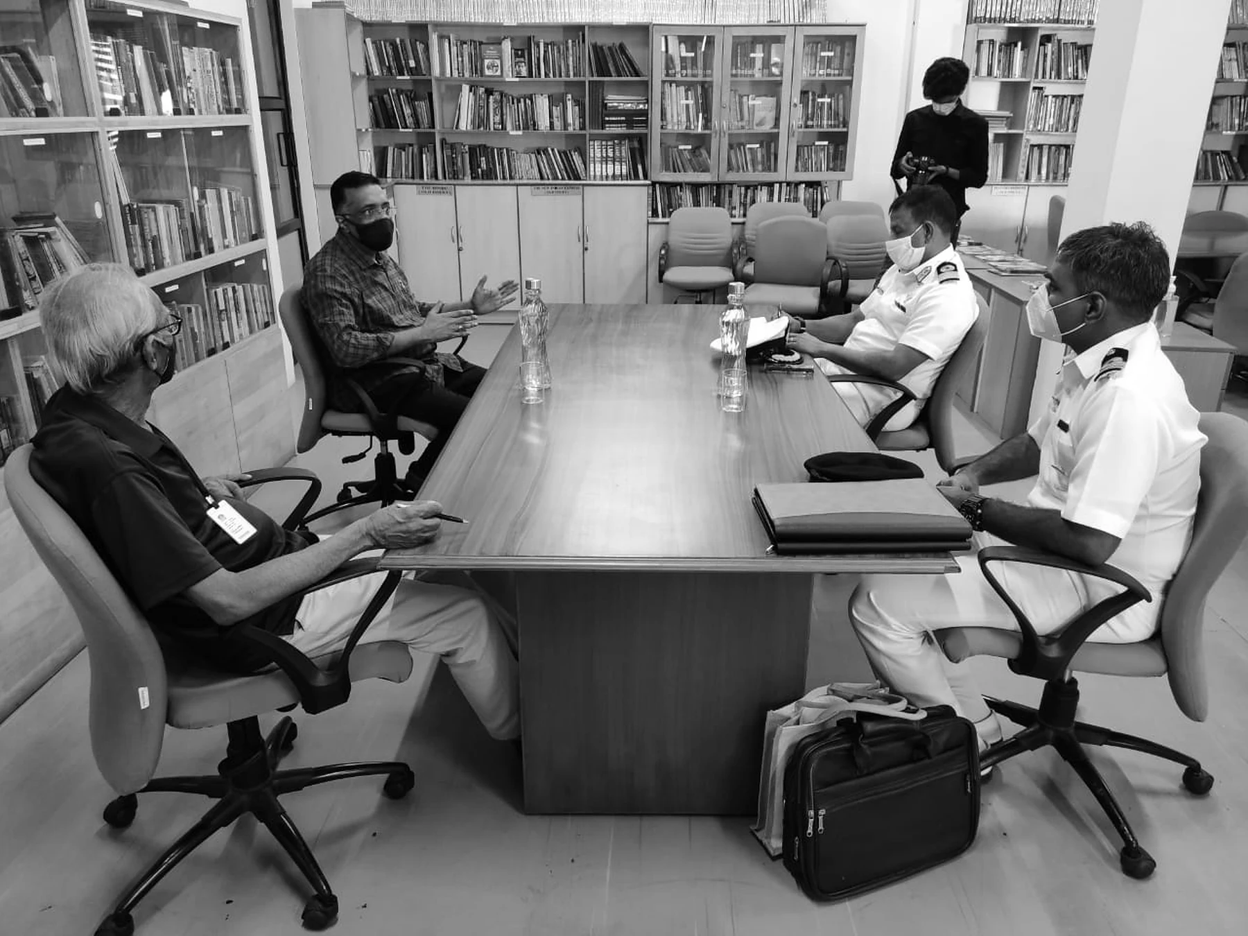 Ravi guiding a small group in a library roundtable conversation